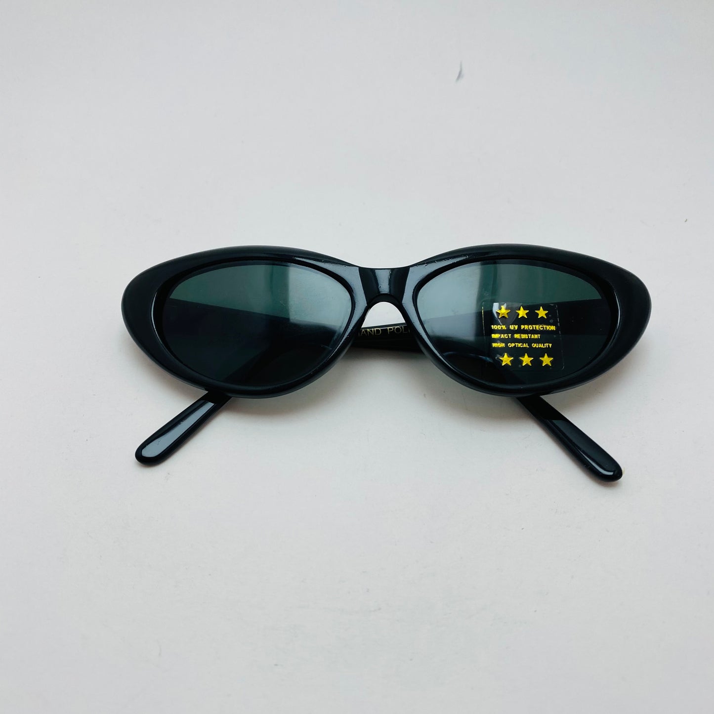 1990s style vintage black triangle frame sunglasses with grey lens 